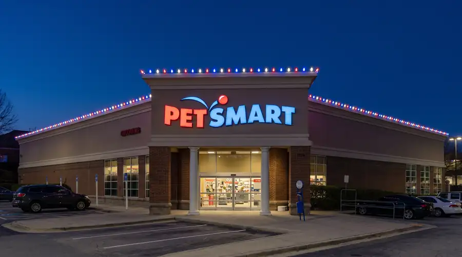 Retail storefront holiday lighting with roofline lights across a customer-facing commercial building