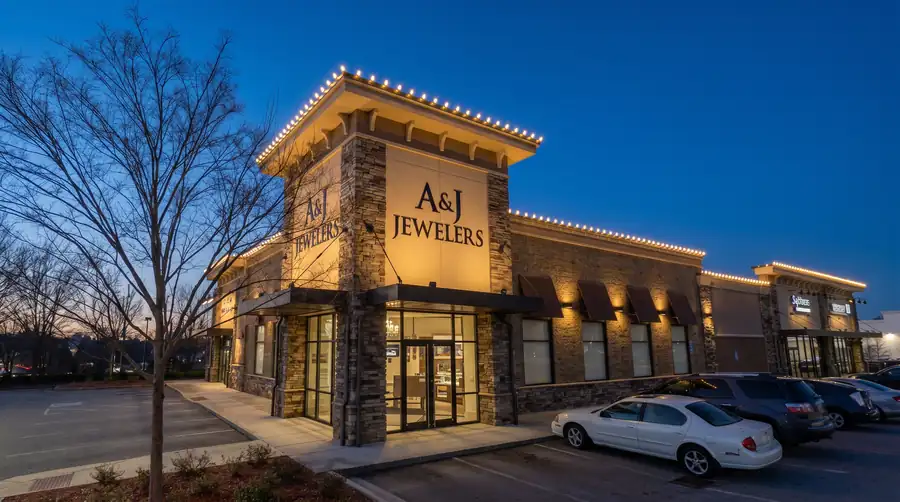Commercial storefront holiday lighting with illuminated roofline and customer-facing entry